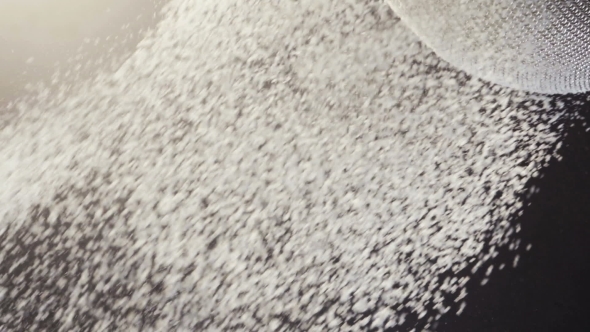 Flour Falling Through a Metal Sieve alt