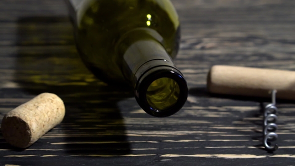 Corkscrew, Cork, Bottle And Glass Of Red Wine On a Wooden Table