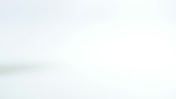 Old 35 Mm Film In Cartridge On a White Background.