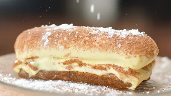 Close Up Appetizing Eclair Sprinkling Sugar Powder Slow Motion alt