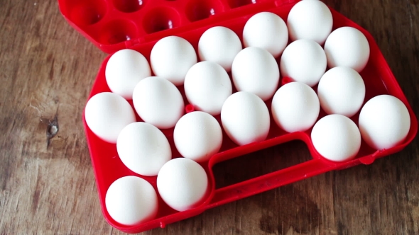 Raw Eggs In a Red Plastic Tray Or Box alt