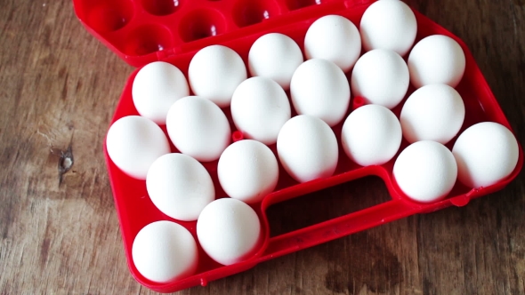 Raw Eggs In a Red Plastic Tray Or Box alt