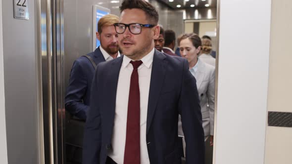 Businesspeople Exiting Elevator alt