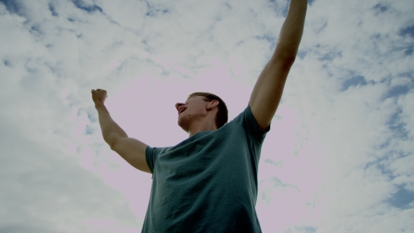 Happy Guy Raises His Hands And Screams