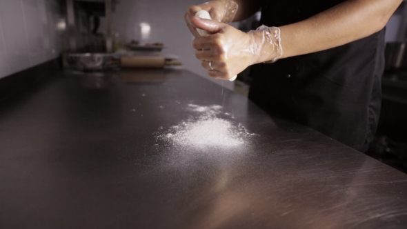 Chef Preparing a Pizza. Chef Tossing Pizza Dough in Commercial Kitchen
