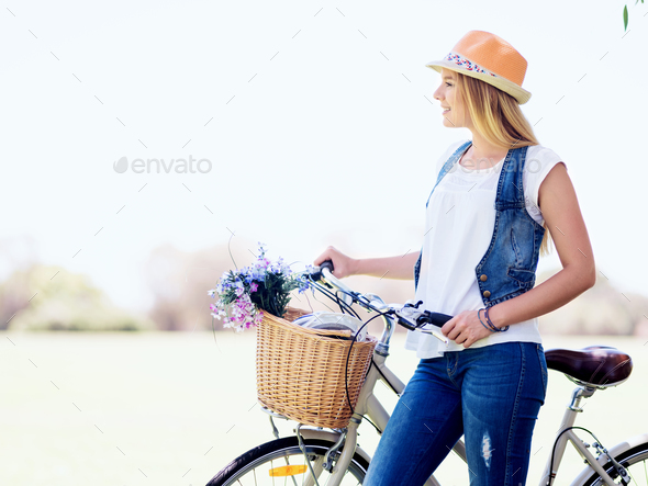 Happy young woman with bicycle - Stock Photo - Images