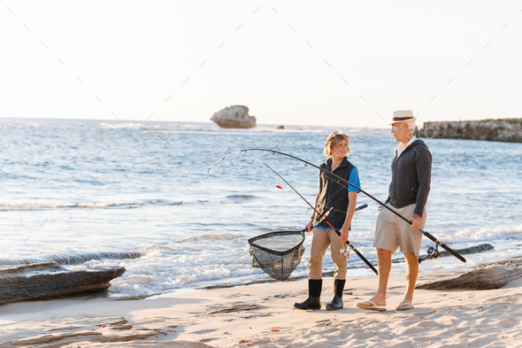 Senior man fishing with his grandson - Stock Photo - Images