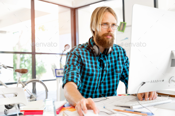 Young man working in office - Stock Photo - Images