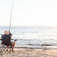 Senior man fishing at sea side - PhotoDune Item for Sale
