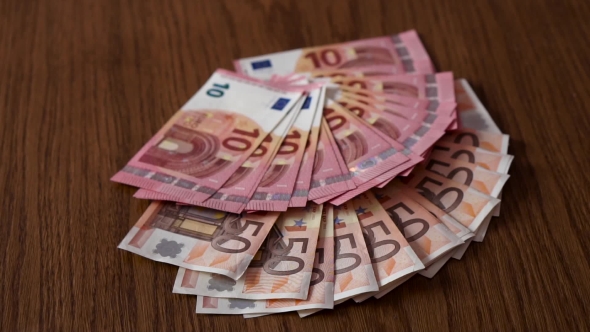 Scattered 50 And 10 Euro On Table alt