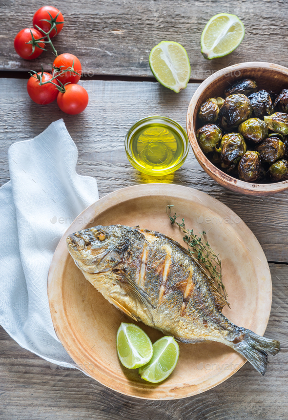 Grilled Dorade Royale Fish with fresh and baked vegetables Stock Photo