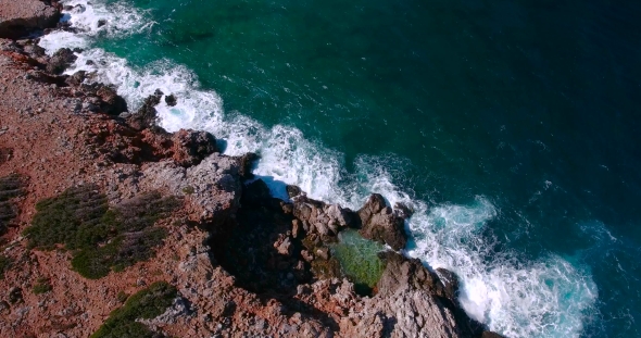 Blue Sea, Waves Breaking In Cliffs At Shore