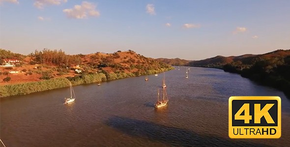Boats at Guadiana River sunset in Algarve Portugal alt