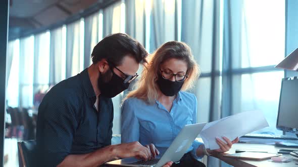 Two Colleagues Talking In Face Mask Office On Covid19 Coronavirus Pandemic Quarantine Lockdown. alt