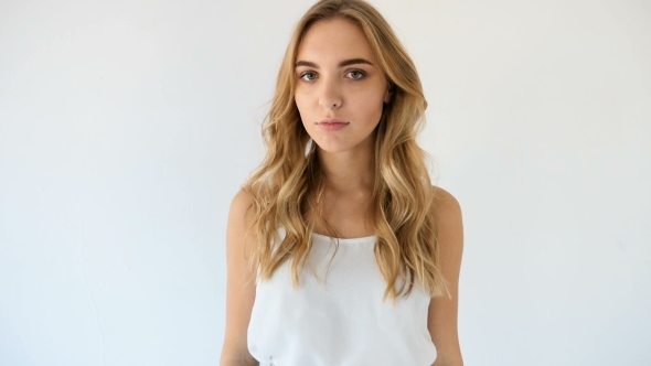 Model In Short Denim Shorts Goes Barefoot On The White Floor