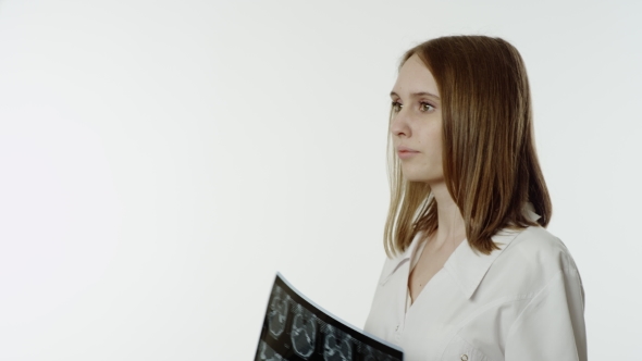 Female Doctor Looking At X-ray alt