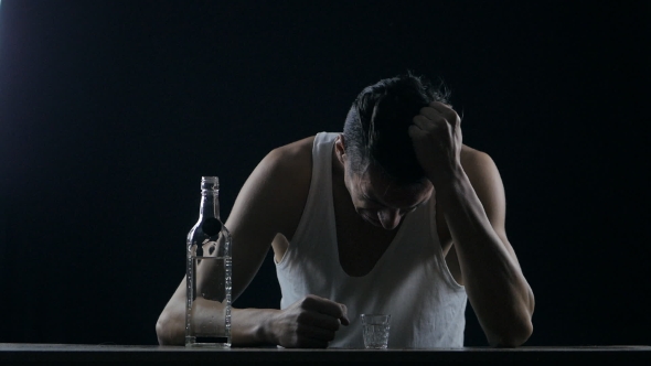Depressed Man Crying With a Bottle Of Vodka. Man In Despair alt