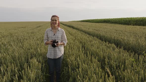 Smiling Girl with Black Glasses Looks on the Camera alt