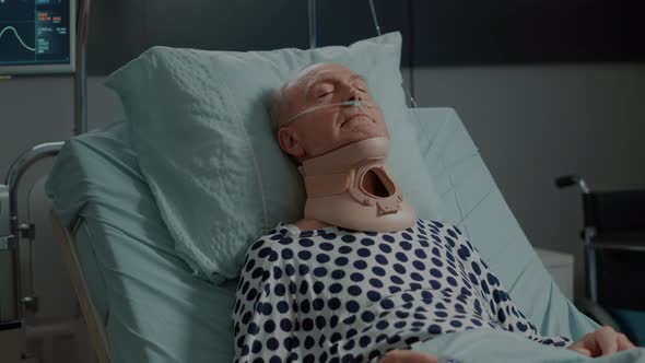 Portrait of Elder Patient Sitting with Cervical Neck Collar alt