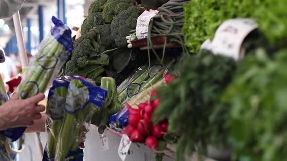 Caucasian Woman with Blond Hair in Medical Protective Mask Chooses Broccoli and Cauliflower at