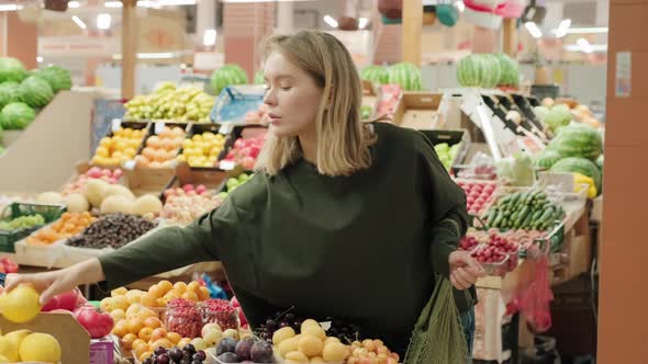Young Woman Shopping for Fresh Produce at Market alt