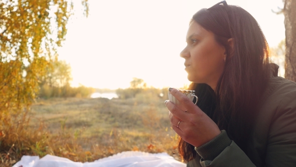 Young Beautiful Woman Having Hot Tea At Sunset Relaxing And Enjoying Nature Scene In