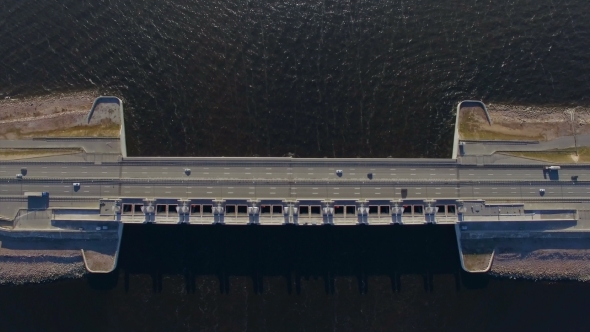 Aerial view of the Bridge By Moving Cars And Trucks. This Bridge Is Part Of a Dam In