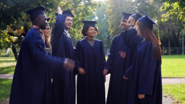 Happy Students In Mortar Boards Making High Five 31 alt