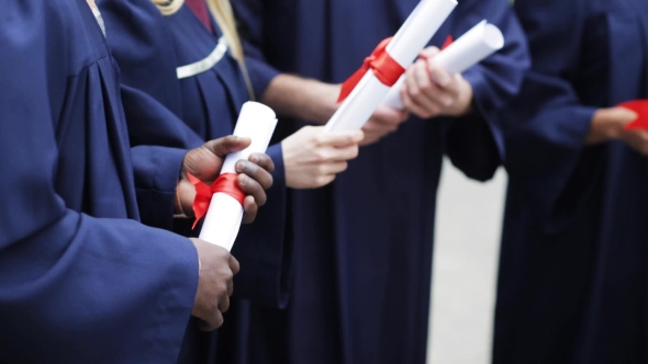 Students In Bachelor Gowns Holding Diploma Scrolls 51 alt