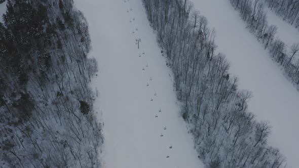 Ski trails on an unused moutain AERIAL Tilt up to reveal the peak alt