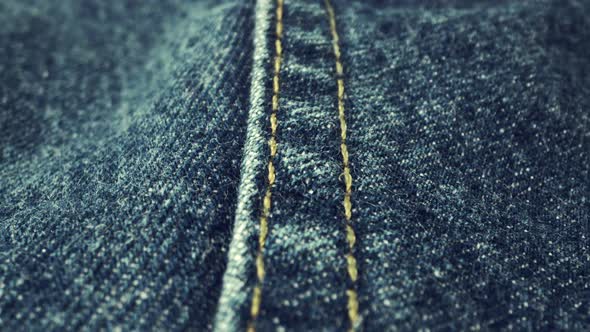Extreme Detailed of Blue Denim Jeans Texture in Dolly Shot Over Cloth Surface alt