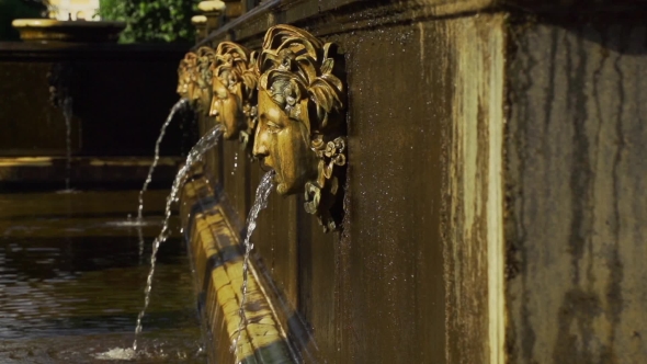 Human Heads Fountain In Park Peterhof