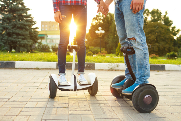 Young couple riding hoverboard - Stock Photo - Images
