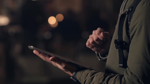Handsome Young Man With Tablet Pc Navigating In The Night Streets alt