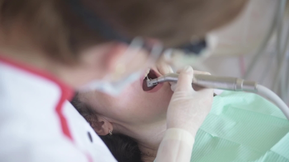 Dentist Treats a Patient