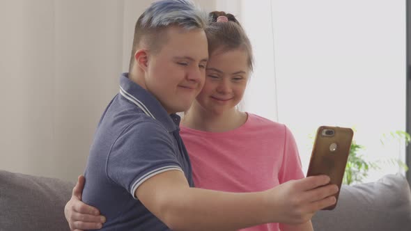 Young Couple with Down Syndrome Taking a Selfie