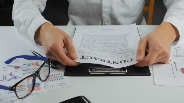 Businessman Tearing a Contract In Pieces alt