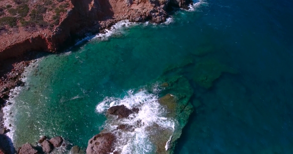 Blue Sea, Waves Breaking In Cliffs At Shore