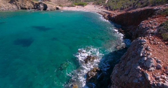 Blue Sea, Waves Breaking In Cliffs At Shore