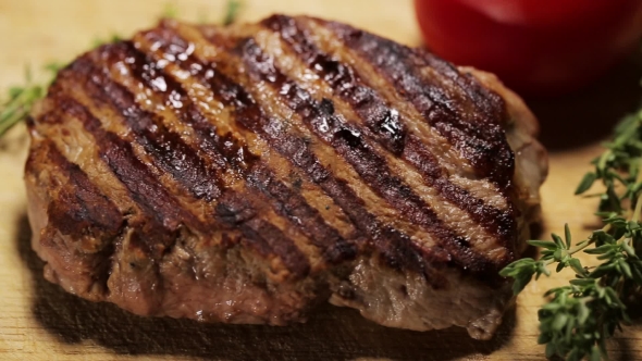 Grilled Steak On The Wooden Surface