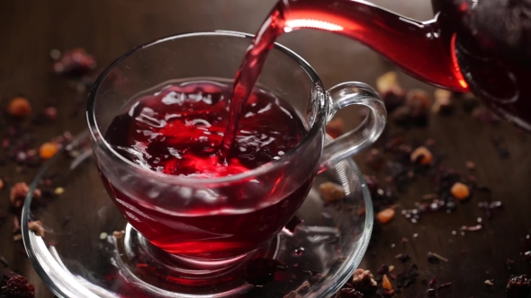 Hibiscus Tea Pouring Into Transparent Glass