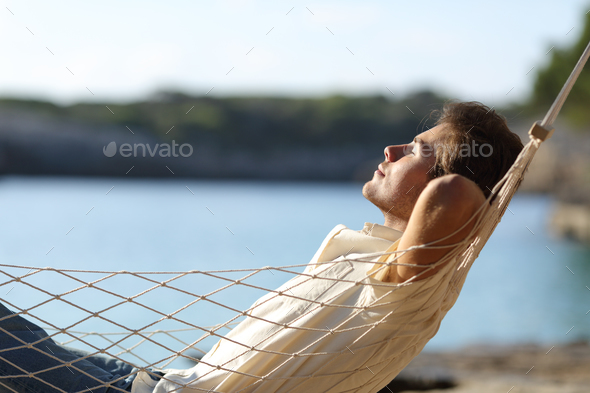 Man relaxing on a hammock in the beach
