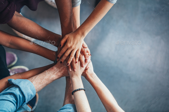 Stack of hands showing unity and teamwork