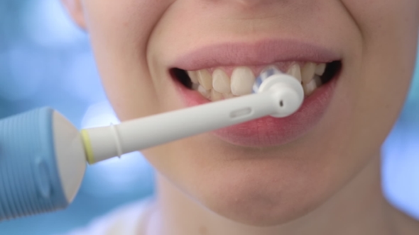 Girl Brushing Her Teeth Electronic Toothbrush