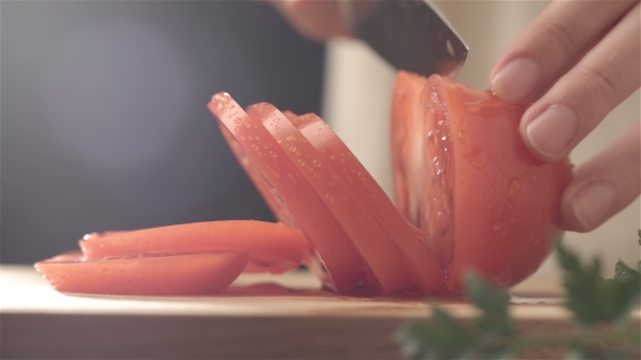 Female Hands Cutting Tomato