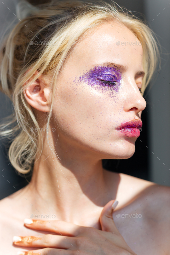 Young Woman With Creative Purple Makeup