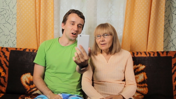 Adult Son And Elderly Mother Making Video Call Via Telephone