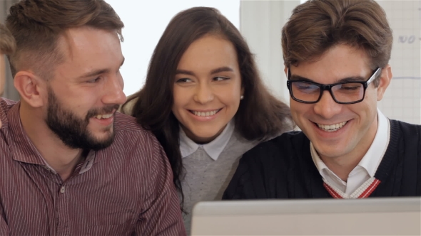 Members Of Creative Team Smile To Each Other At The Office alt