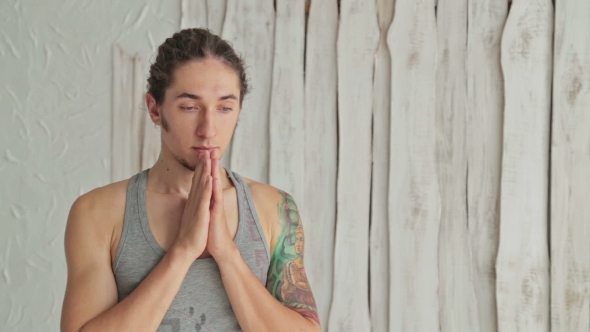Young Sporty Man Practicing Yoga In Fitness Studio Making Hand Greeting Namaste