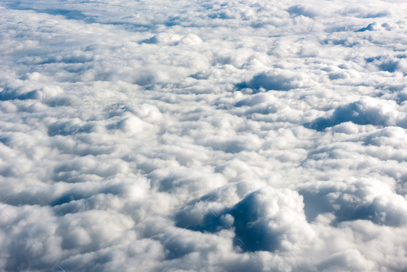 Close up view of fluffy clouds over a blue sky Stock Photo by
